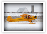 Roger Disrud and Mark trying out the skis on Roger's 1946 J3-C Piper Cub